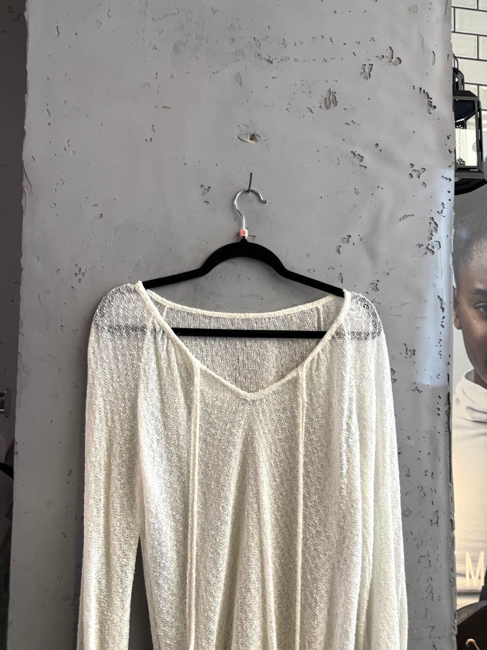 BERLIN VINTAGE CORNER ivory sheer knit V-neck pullover sweater with drawstring detail and long sleeves.