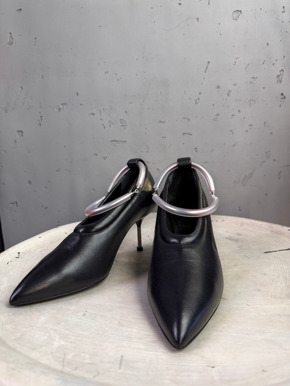 BERLIN VINTAGE CORNER Jil Sander black leather pointed-toe pumps with sculptural translucent ankle rings and stiletto heels.