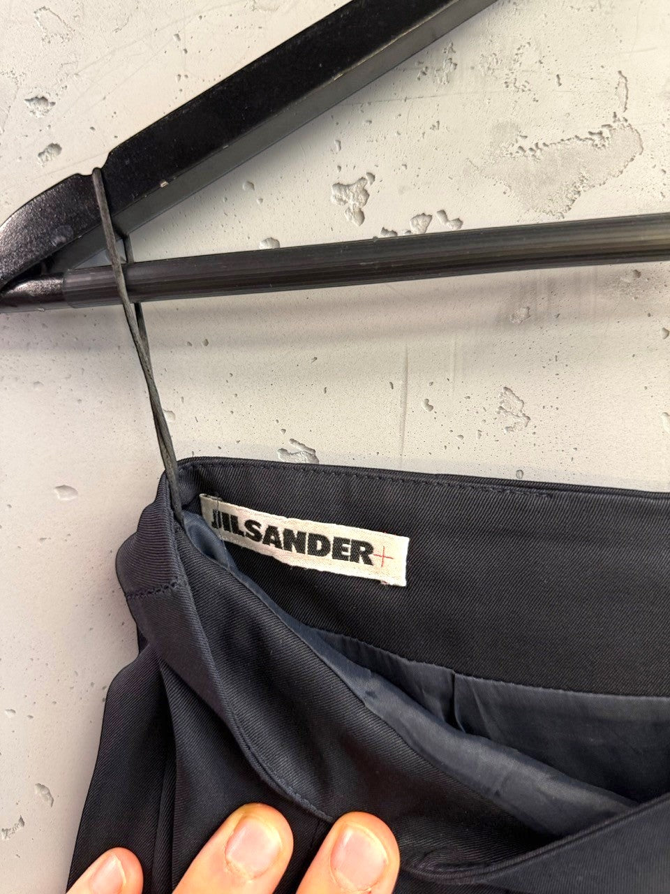 BERLIN VINTAGE CORNER JIL SANDER black tailored pencil skirt with interior brand label on a hanger
