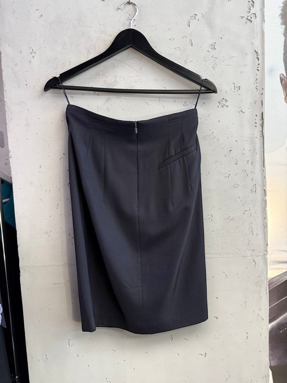 BERLIN VINTAGE CORNER JIL SANDER black tailored pencil skirt with back zipper and dart detailing on a hanger