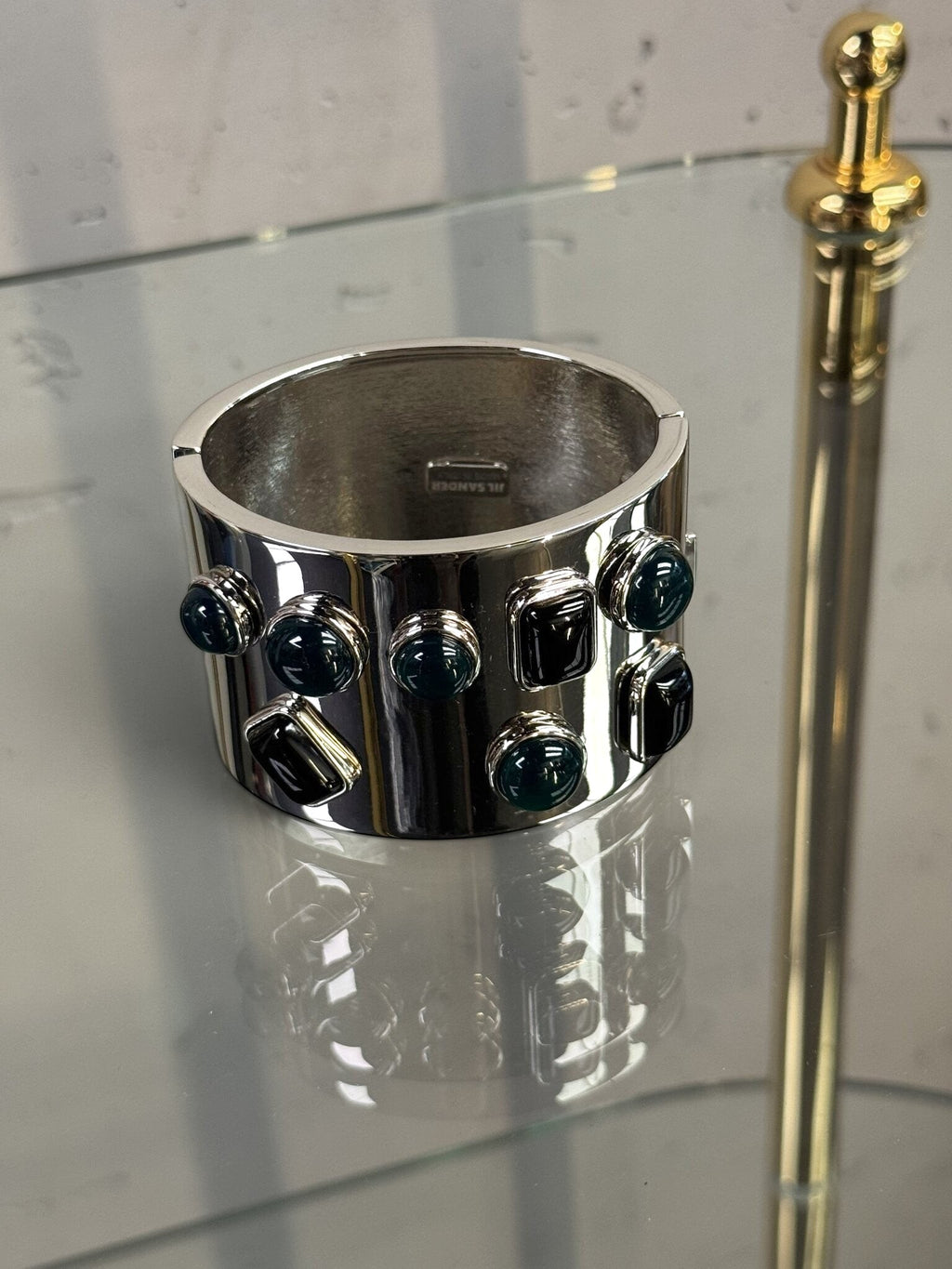 BERLIN VINTAGE CORNER Jil Sander wide silver-tone hinged cuff bracelet with dark jewel-toned stone accents.