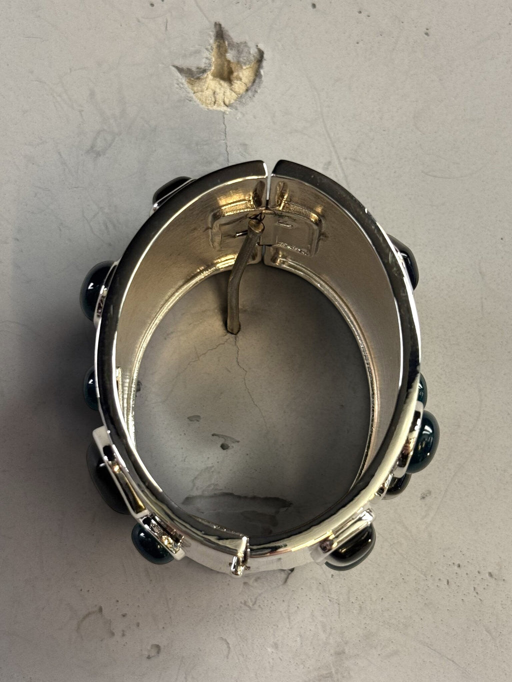 BERLIN VINTAGE CORNER Jil Sander wide silver-tone hinged cuff bracelet with dark jewel-toned stone accents.