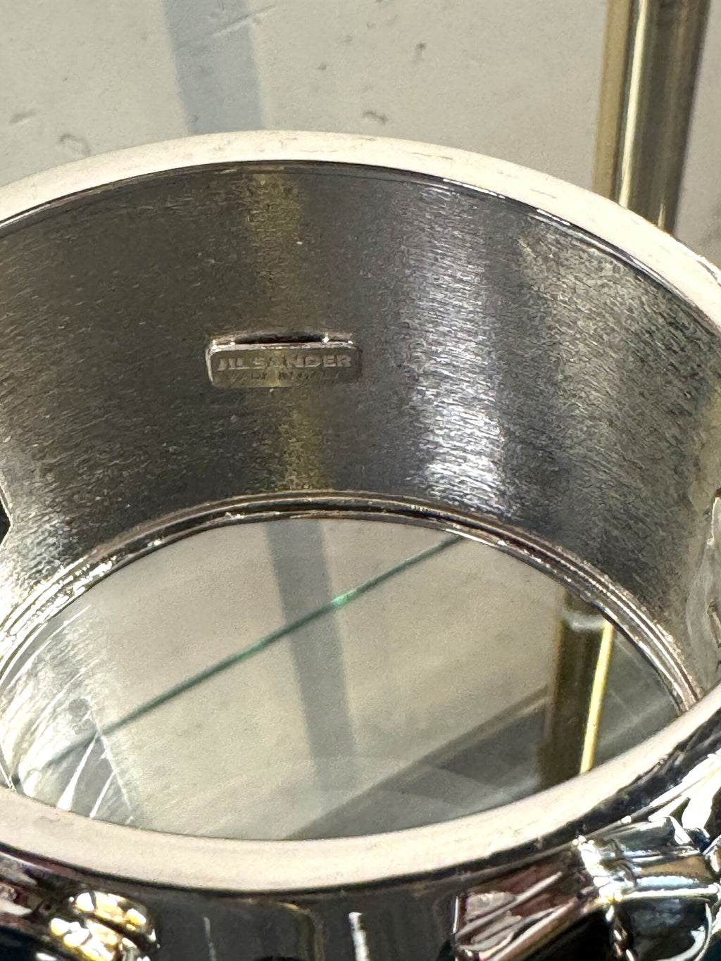 BERLIN VINTAGE CORNER Jil Sander wide silver-tone hinged cuff bracelet showing the interior brand hallmark engraving