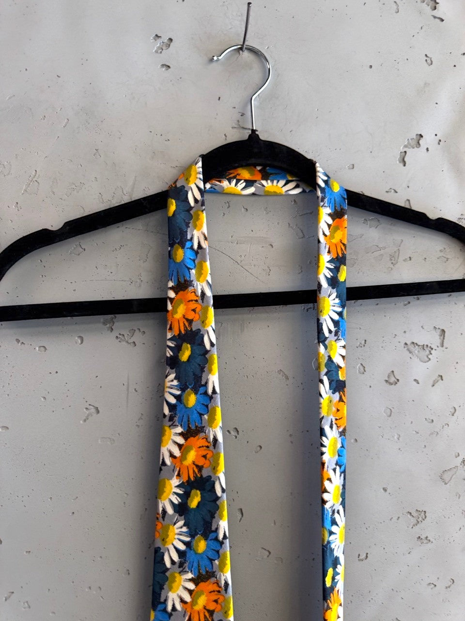 BERLIN VINTAGE CORNER JOOP! navy blue tie with scattered white, orange, and blue daisy print. Classic width.