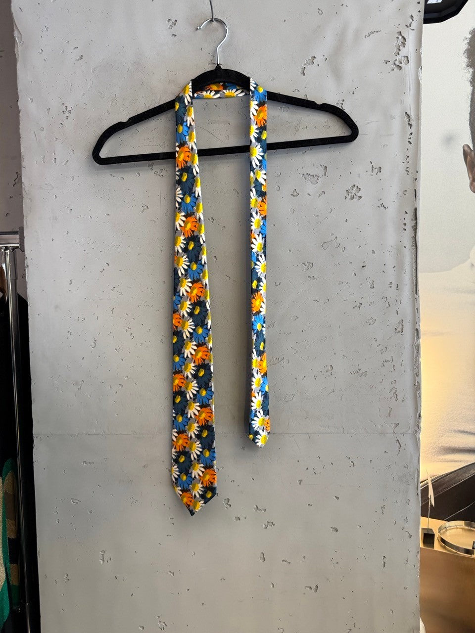 BERLIN VINTAGE CORNER JOOP! navy blue tie with scattered white, orange, and blue daisy print.