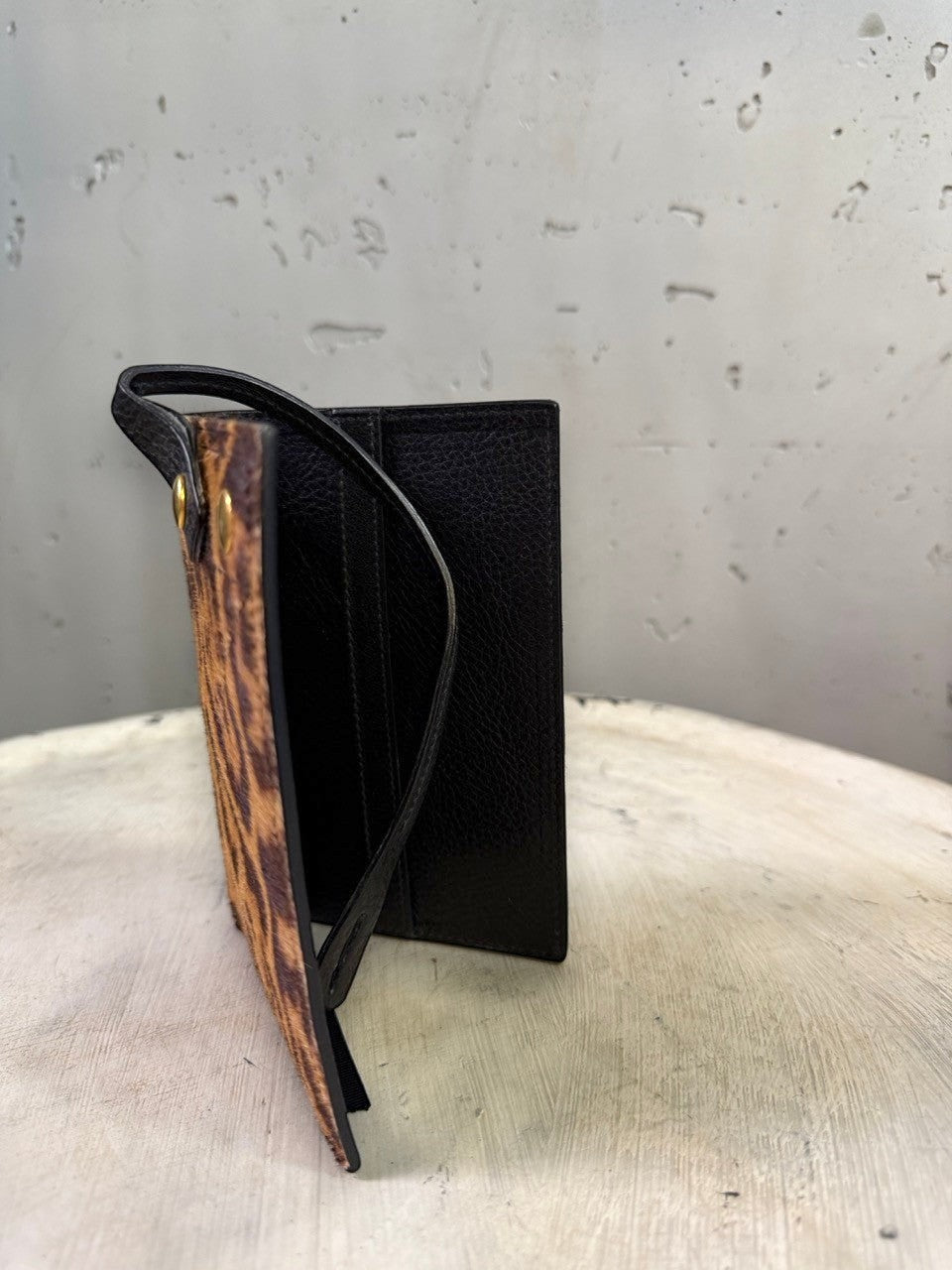 BERLIN VINTAGE CORNER leopard print calf hair cardholder with black leather interior and strap.