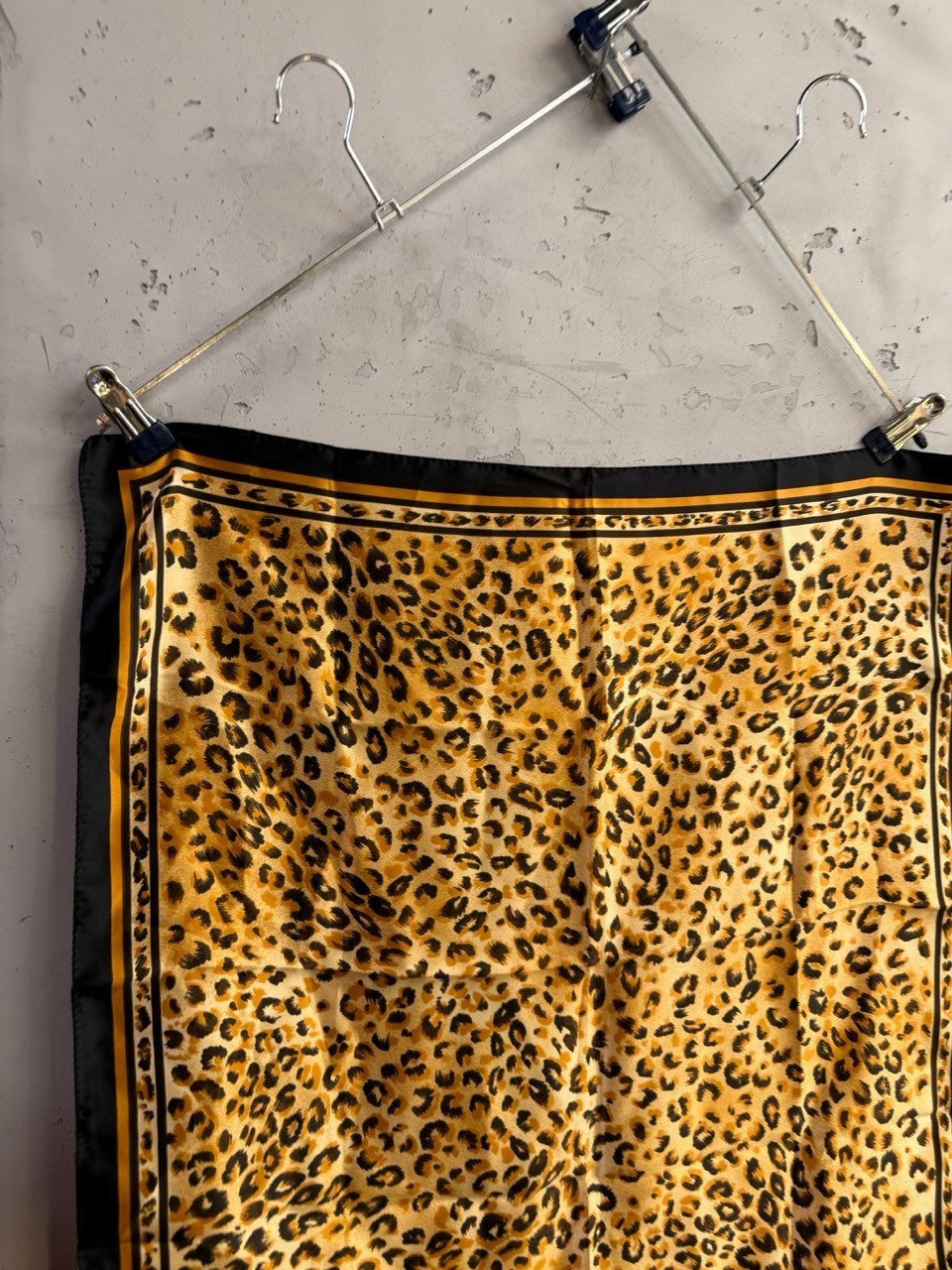 BERLIN VINTAGE CORNER square scarf in leopard print with gold, tan, and black tones and a decorative border.