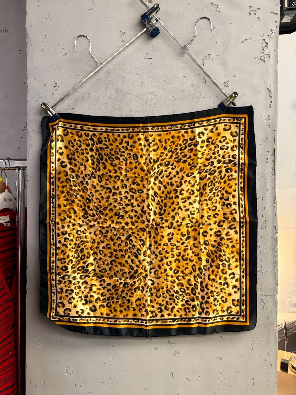 BERLIN VINTAGE CORNER square polyester scarf featuring a gold, tan, and black leopard print with a decorative border.