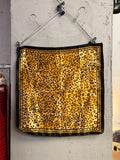 BERLIN VINTAGE CORNER square polyester scarf featuring a gold, tan, and black leopard print with a decorative border.