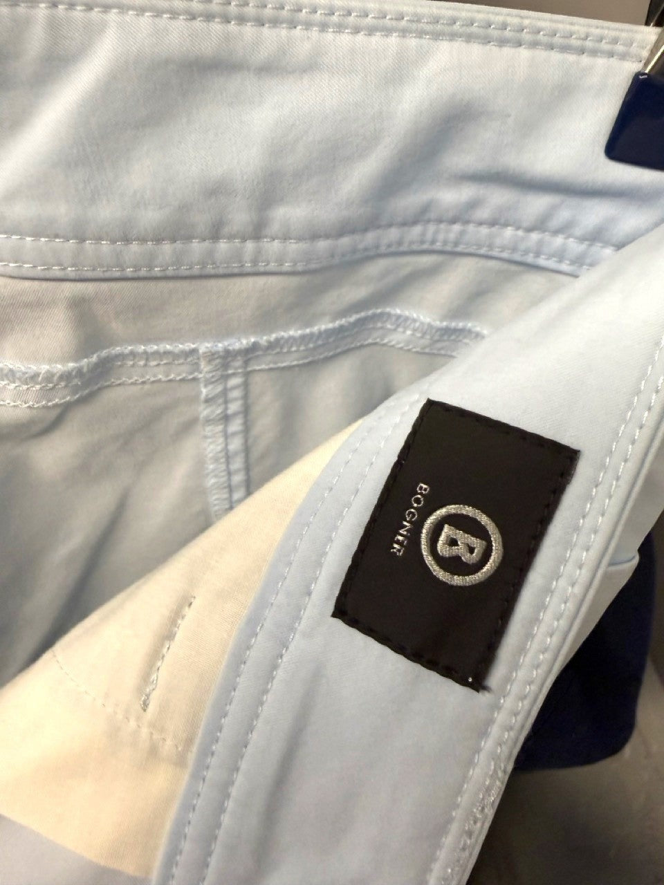 BERLIN VINTAGE CORNER light blue cropped trousers with embroidered logo detail.
