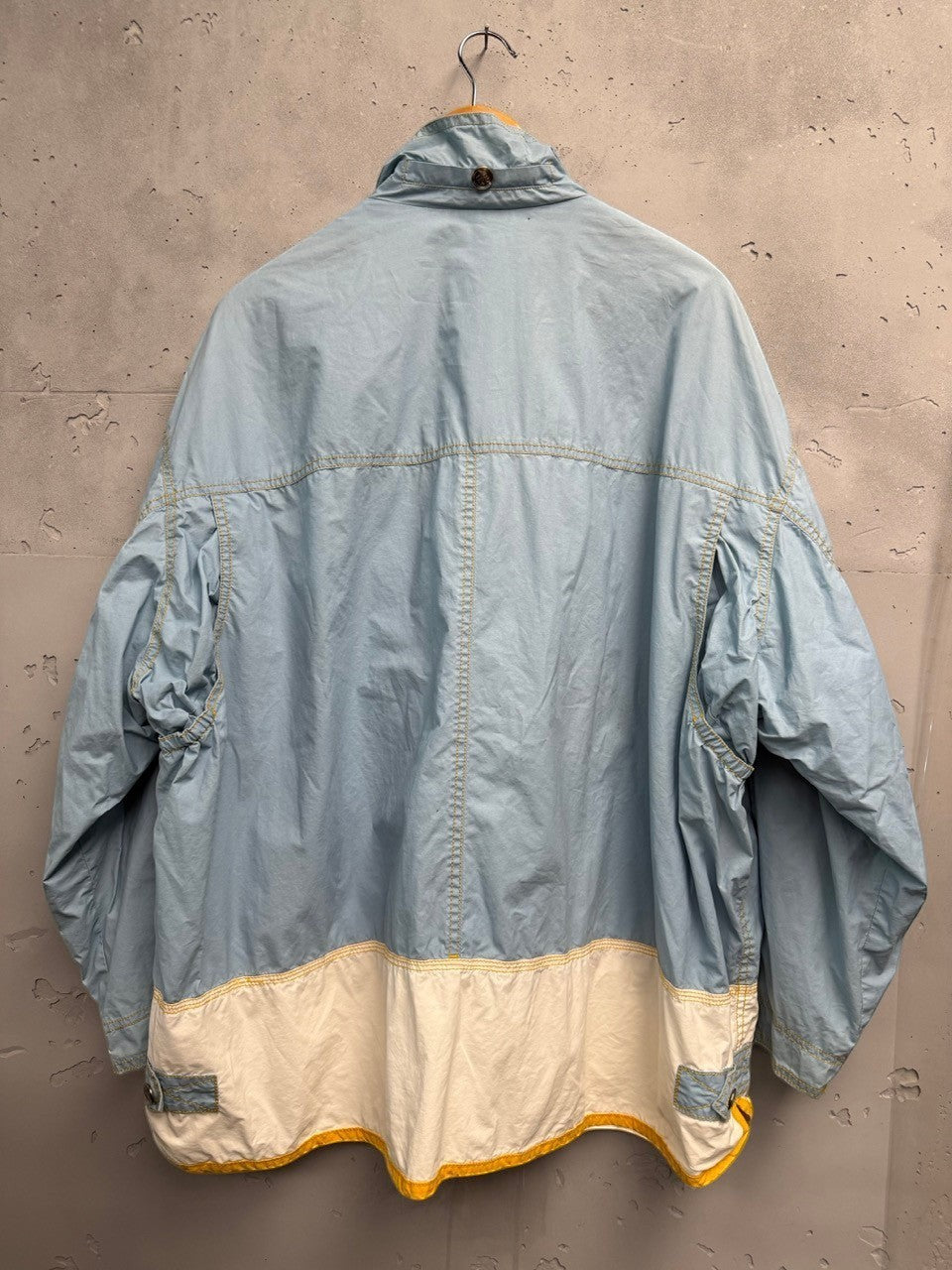 BERLIN VINTAGE CORNER light blue lightweight windbreaker jacket with white panel and yellow trim, full zip, snap pockets.
