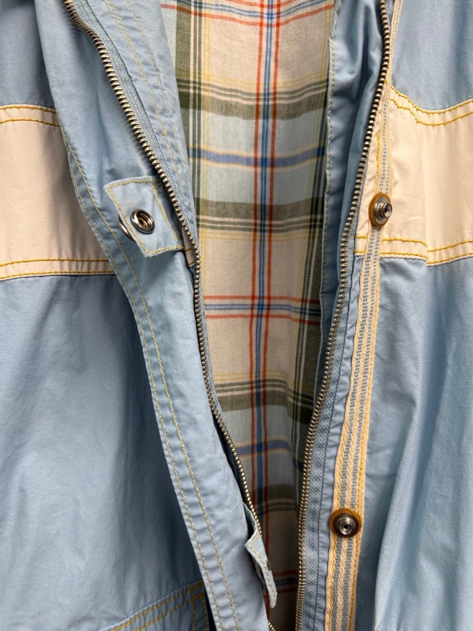 BERLIN VINTAGE CORNER light blue windbreaker jacket with plaid lining, white stripe accents, and snap pockets.