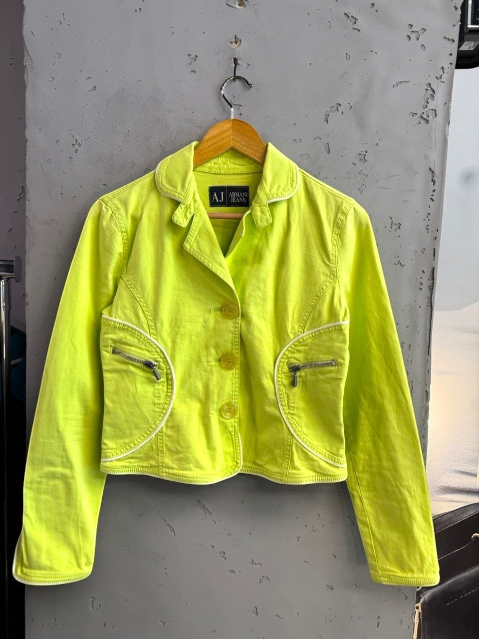 BERLIN VINTAGE CORNER lime green denim jacket with white piping, button-up front, and zippered pockets.