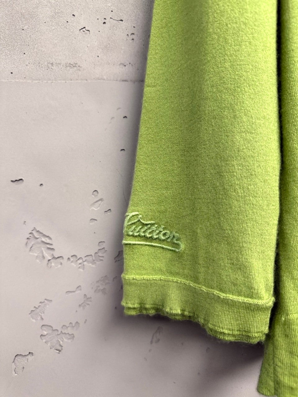 BERLIN VINTAGE CORNER lime green knit cardigan with embroidered logo on sleeve and ruffled hem.