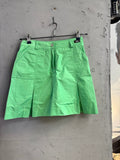 BERLIN VINTAGE CORNER lime green pleated mini skirt with side pockets, belt loops, and button closure.