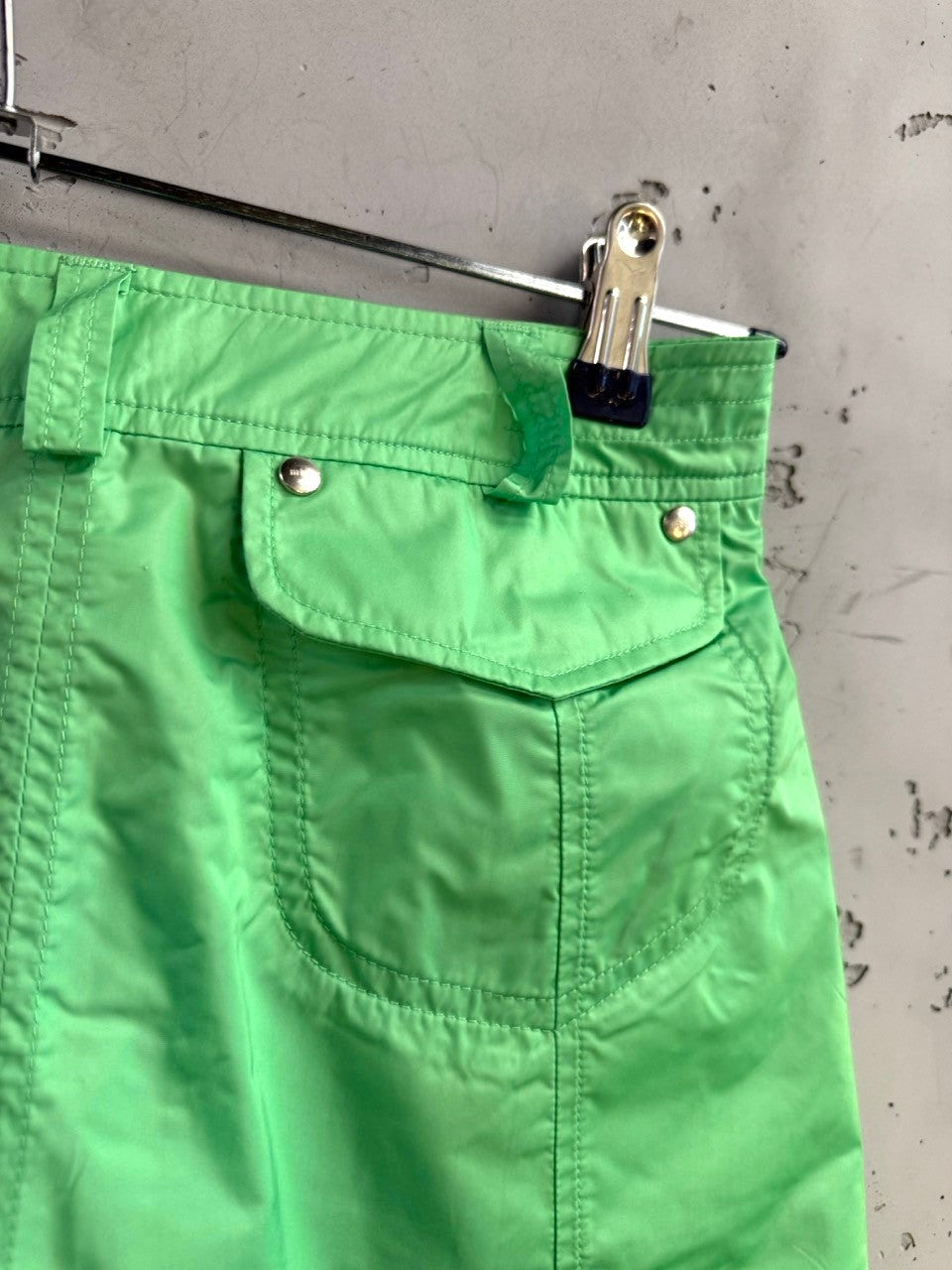 BERLIN VINTAGE CORNER lime green pleated mini skirt with utility pockets, belt loops, and silver button details.