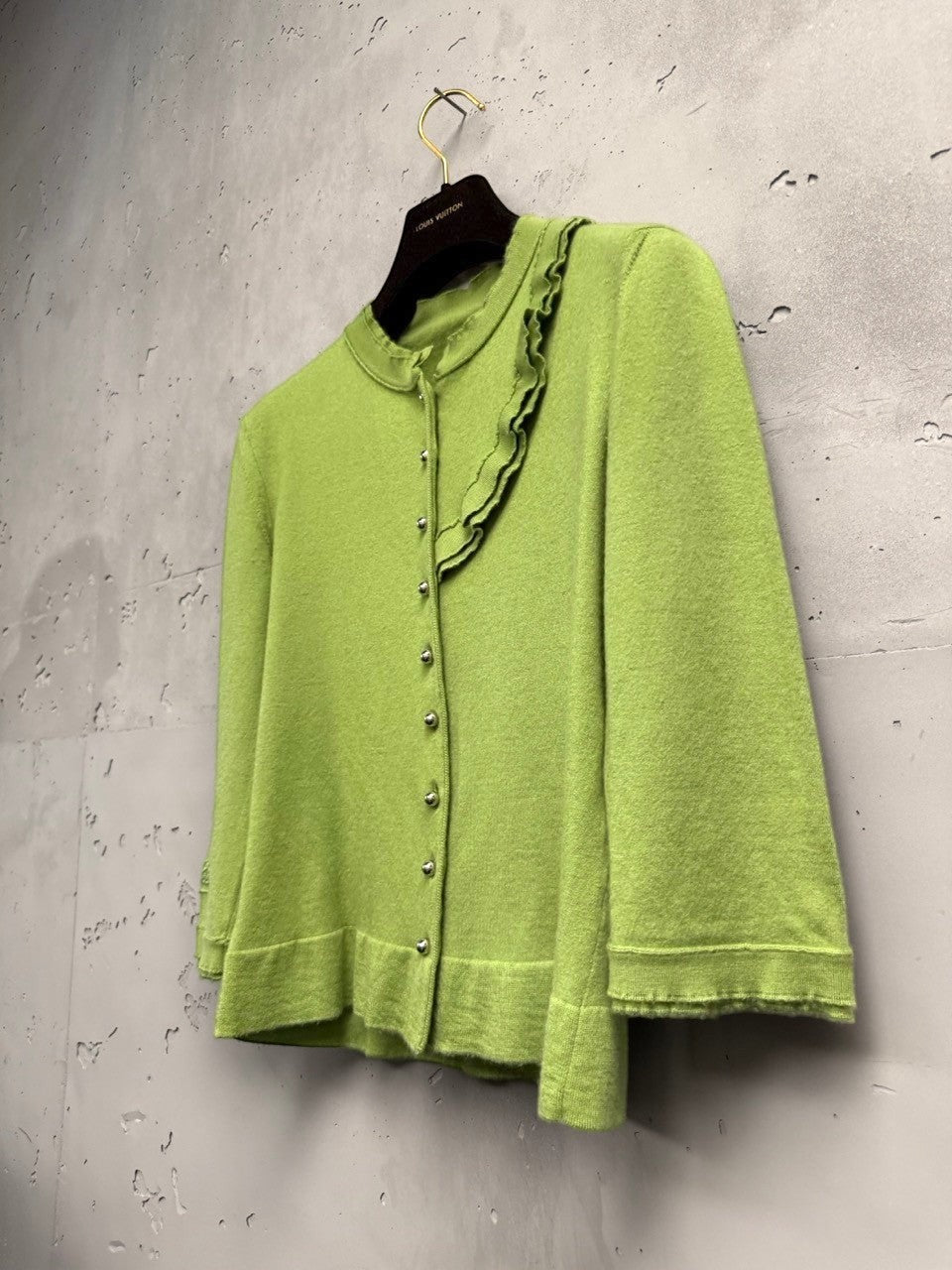 BERLIN VINTAGE CORNER lime green knit cardigan with ruffled neckline, silver buttons, and 3/4 sleeves.