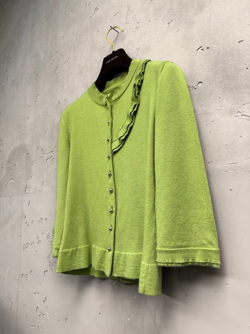 BERLIN VINTAGE CORNER lime green knit cardigan with ruffled neckline and silver buttons. Three-quarter sleeves.