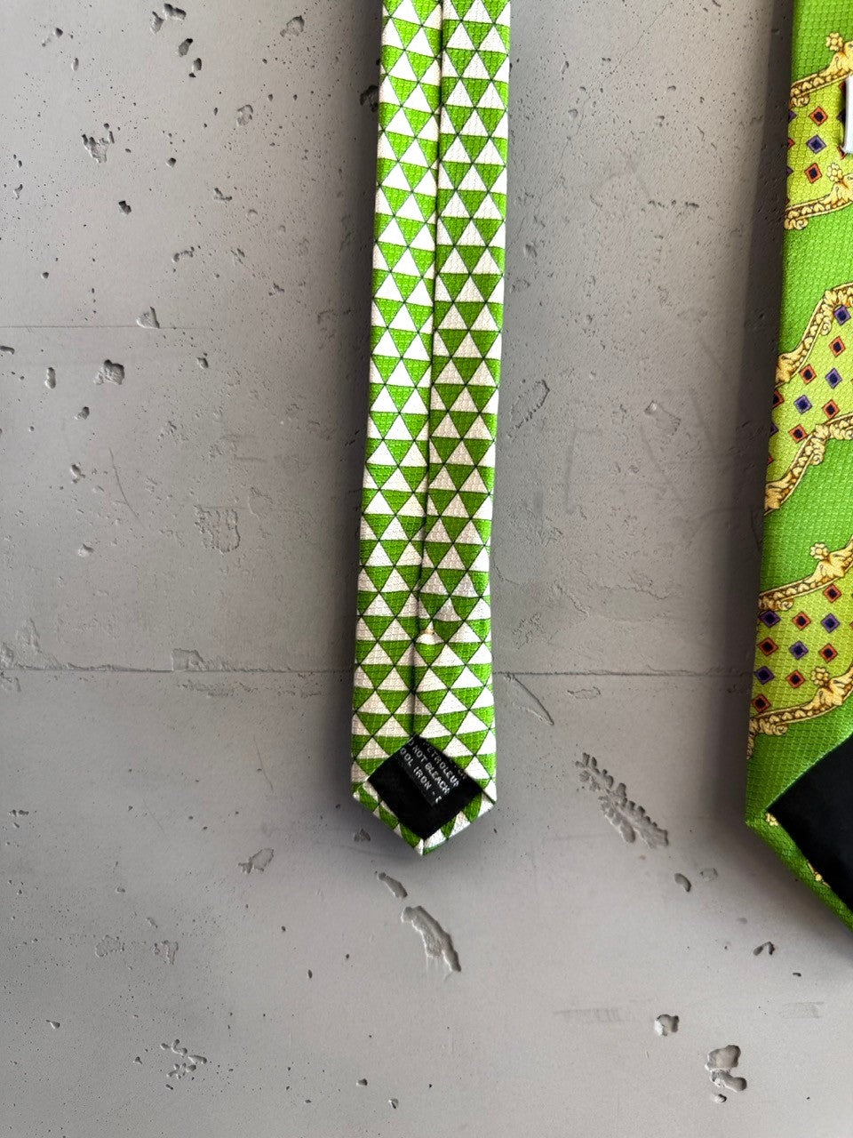 BERLIN VINTAGE CORNER lime green silk necktie with white triangle pattern on reverse and gold baroque motif on front.