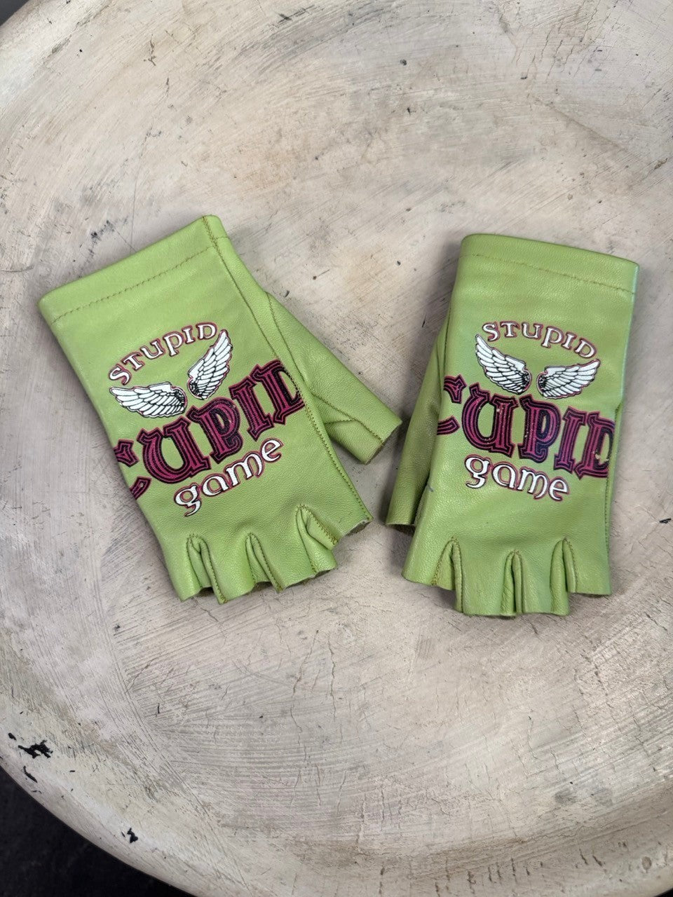 BERLIN VINTAGE CORNER lime green leather fingerless gloves with Stupid Cupid game graphic and wing embroidery