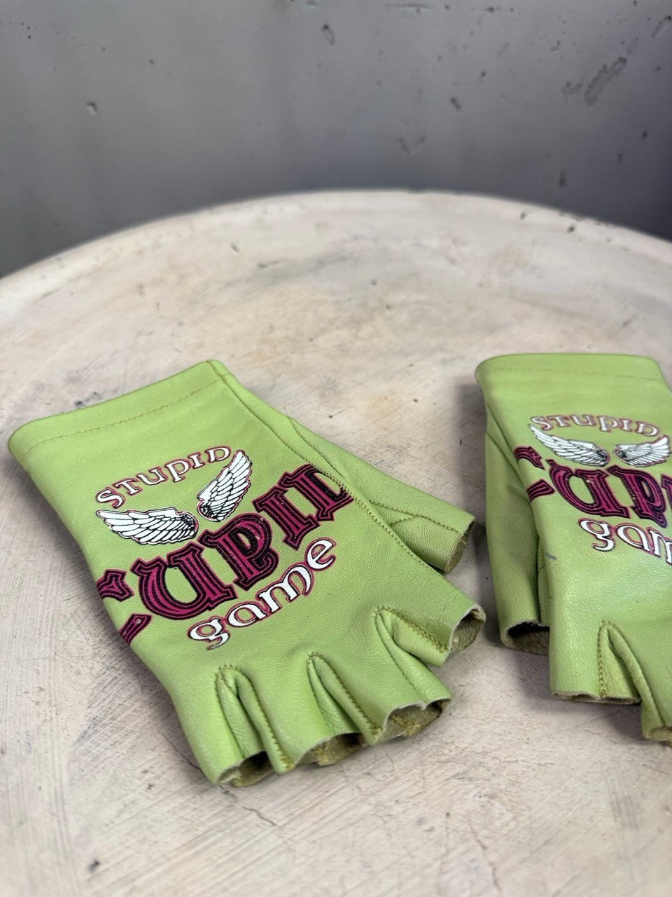 BERLIN VINTAGE CORNER lime green leather fingerless gloves with Stupid Game graphic and wing embroidery