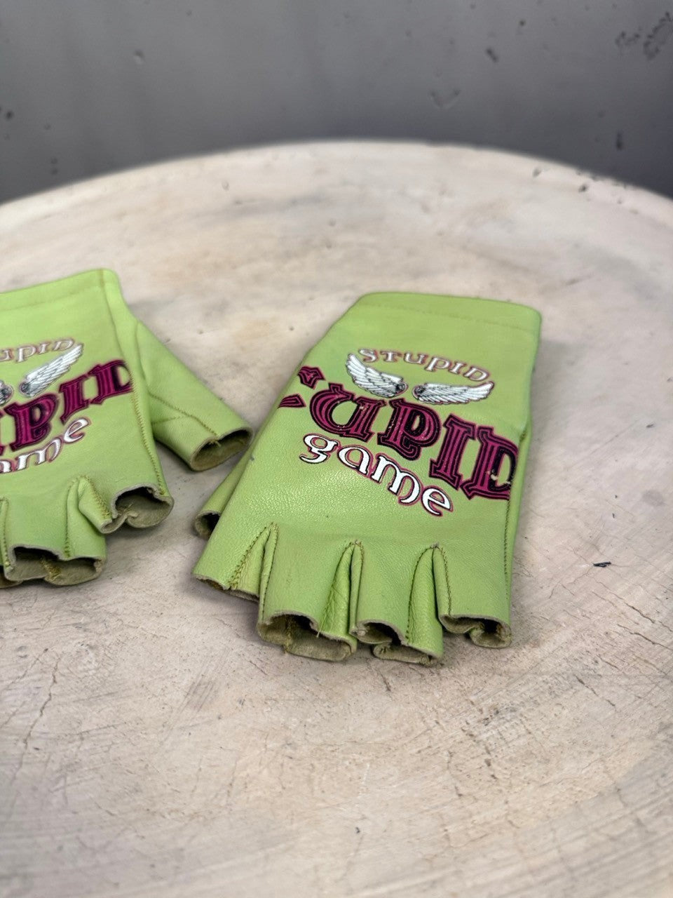BERLIN VINTAGE CORNER lime green leather fingerless gloves with Stupid Game graphic and wing embroidery