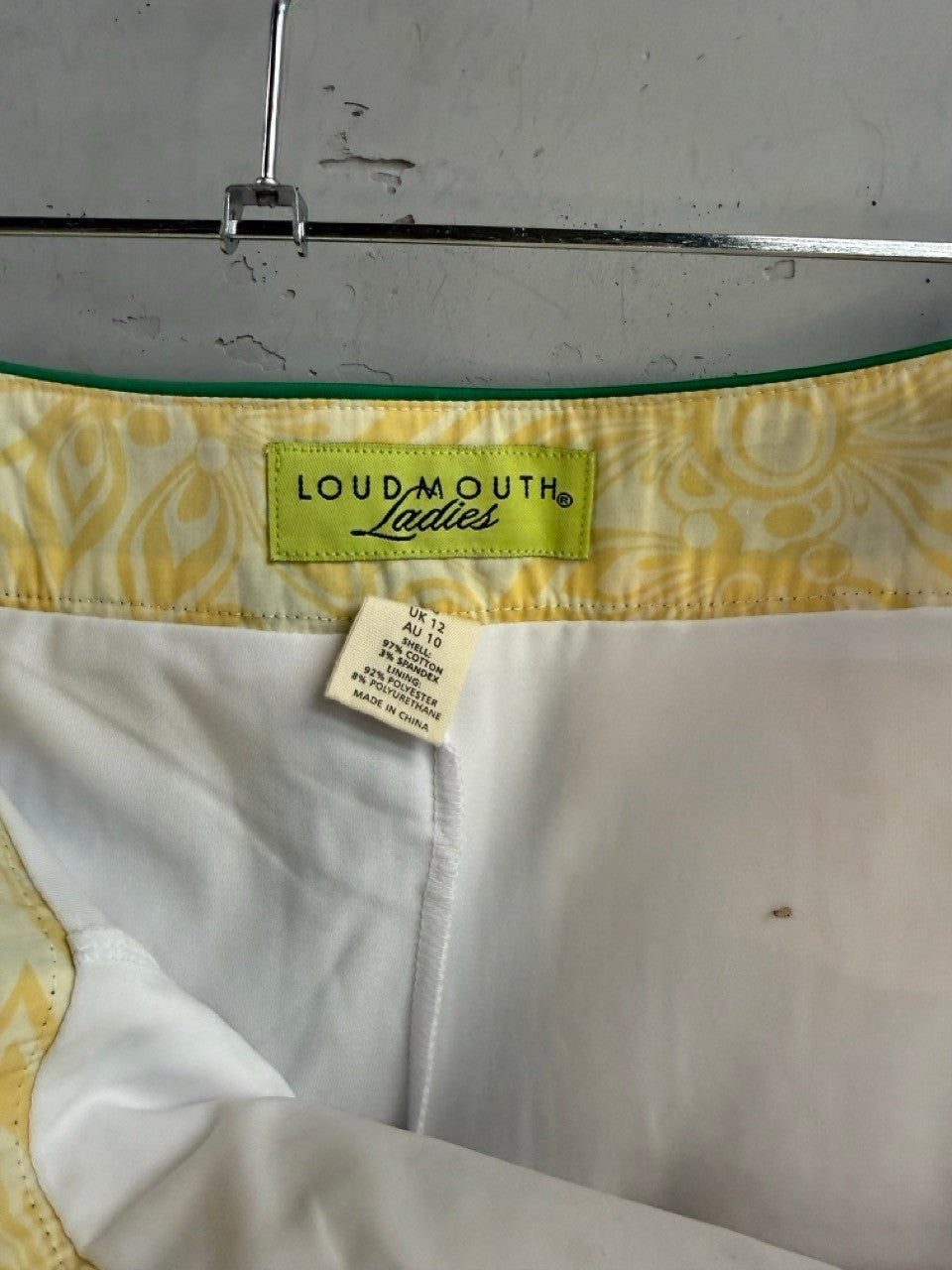 BERLIN VINTAGE CORNER Loudmouth Ladies golf skirt interior label showing cotton spandex blend and size details.