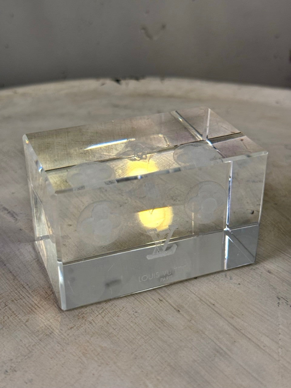 BERLIN VINTAGE CORNER Louis Vuitton crystal paperweight with etched monogram and floral motifs. Clear geometric cube.