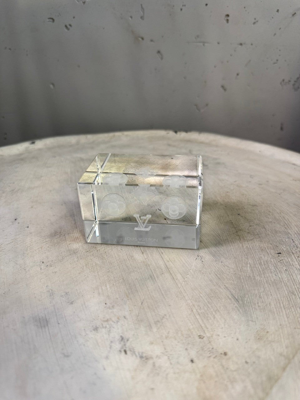 BERLIN VINTAGE CORNER Louis Vuitton crystal cube paperweight with etched monogram and floral motifs.