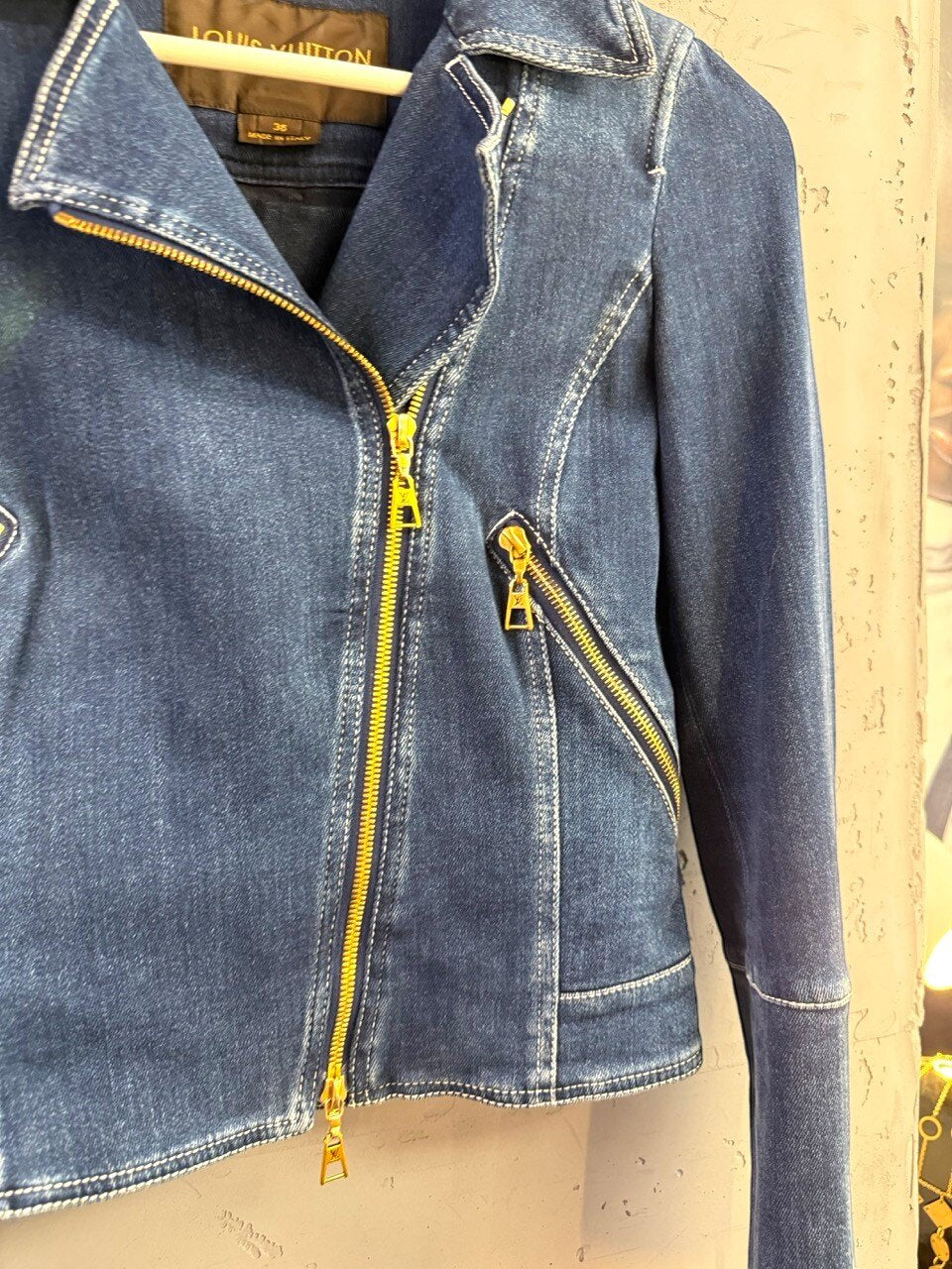 Louis Vuitton denim jacket, close up of the gold zip pull