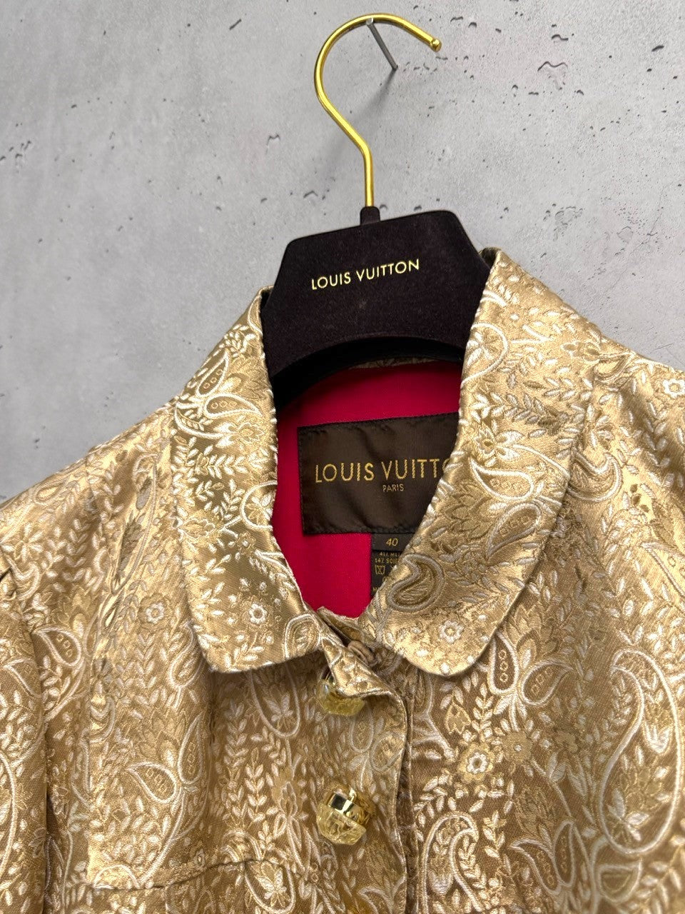 BERLIN VINTAGE CORNER Louis Vuitton gold brocade jacket with paisley pattern, fuchsia lining, and ornate buttons.