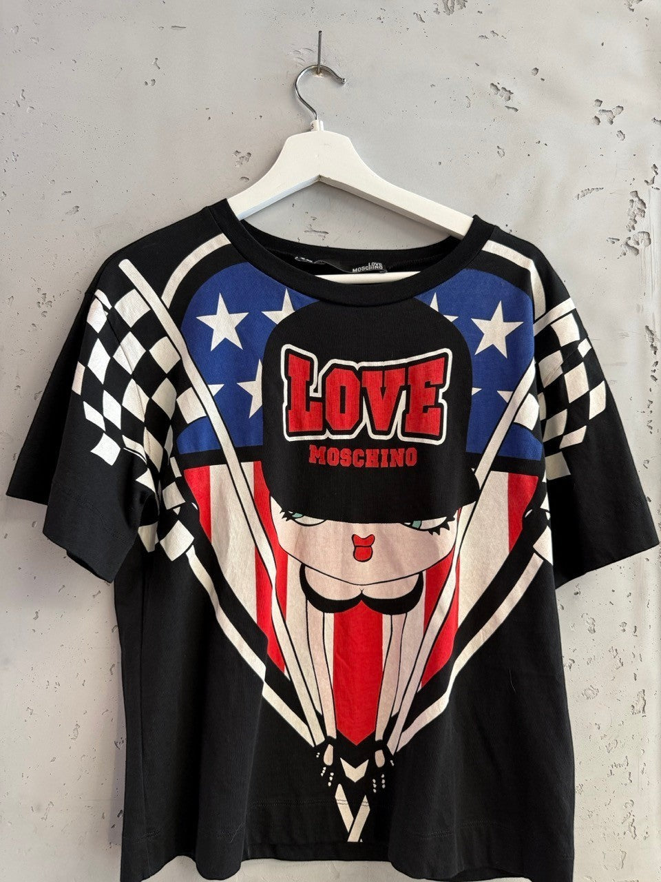 BERLIN VINTAGE CORNER black cotton t-shirt with graphic print featuring cartoon character, stars, stripes, and LOVE MOSCHINO logo.