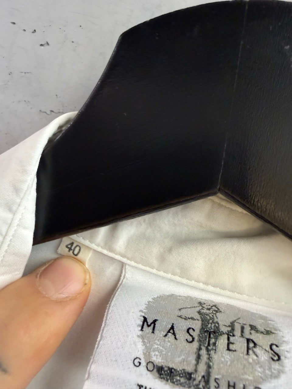 BERLIN VINTAGE CORNER white sleeveless golf shirt with Masters Golf Fashion label and size 40 tag on a hanger
