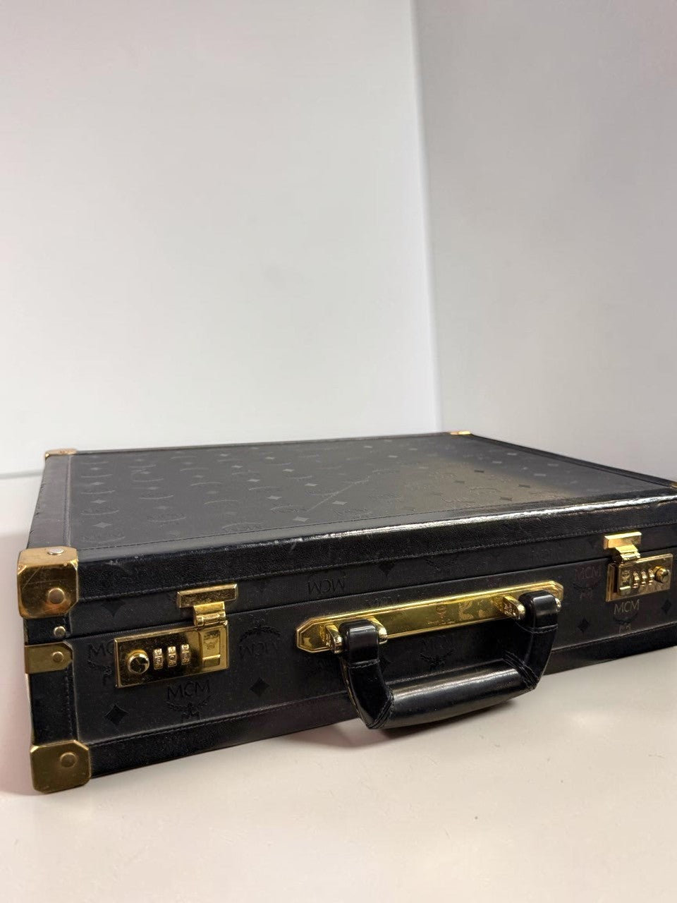 BERLIN VINTAGE CORNER vintage black leather MCM hard shell briefcase with gold-tone hardware and monogram pattern