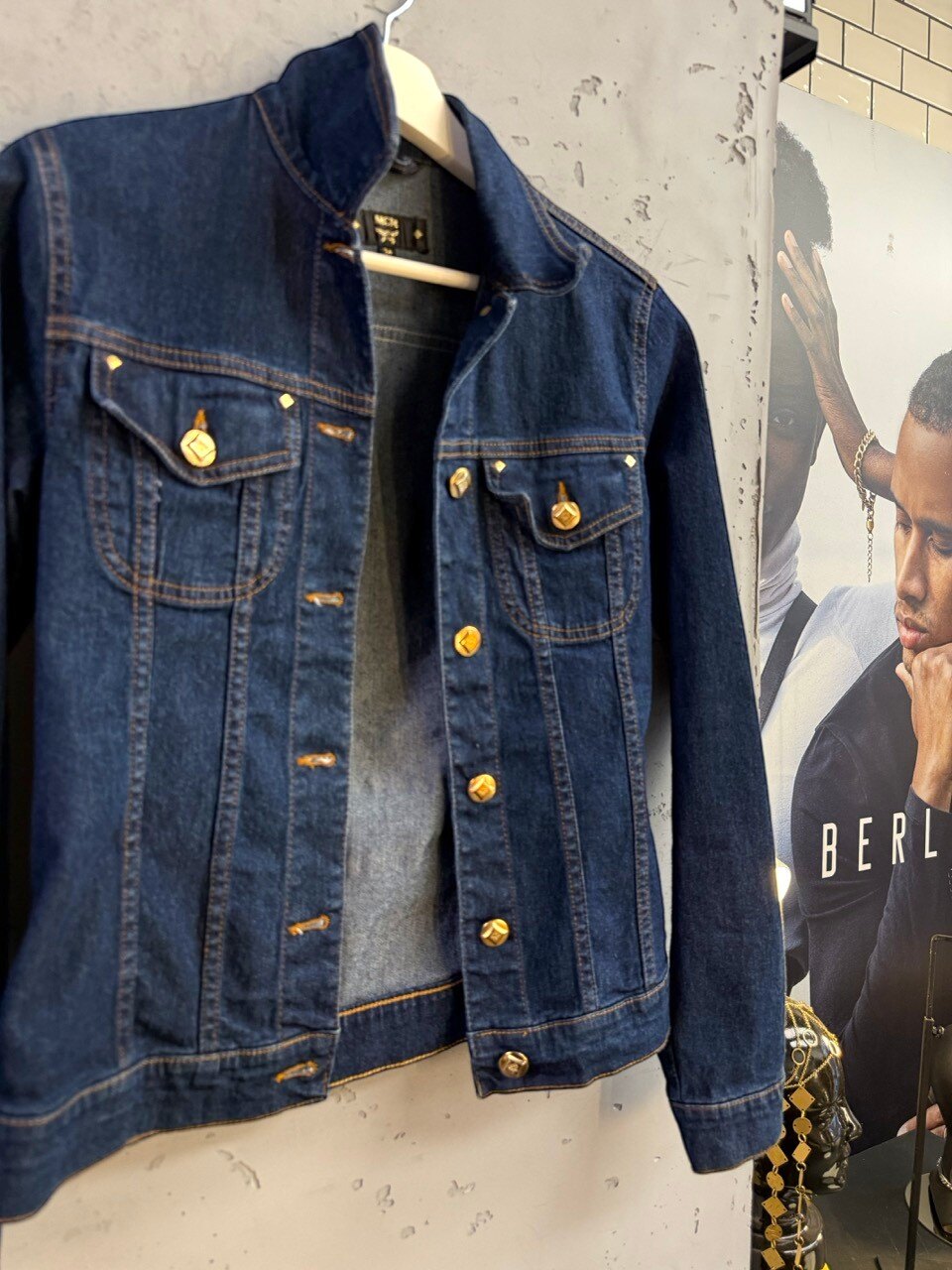 MCM denim jacket on a hanger, open front
