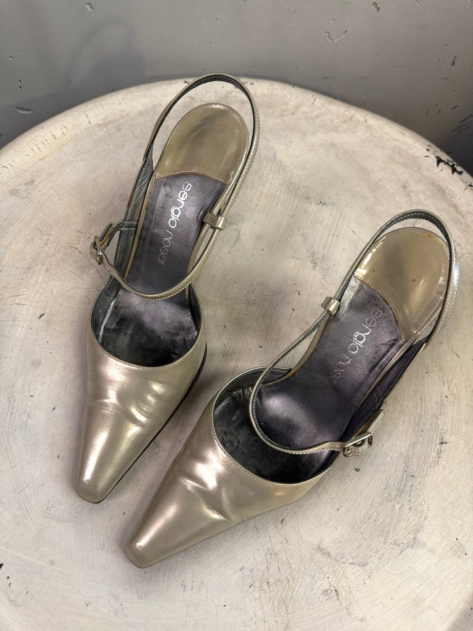 BERLIN VINTAGE CORNER metallic taupe leather pointed toe slingback heels with adjustable ankle straps.
