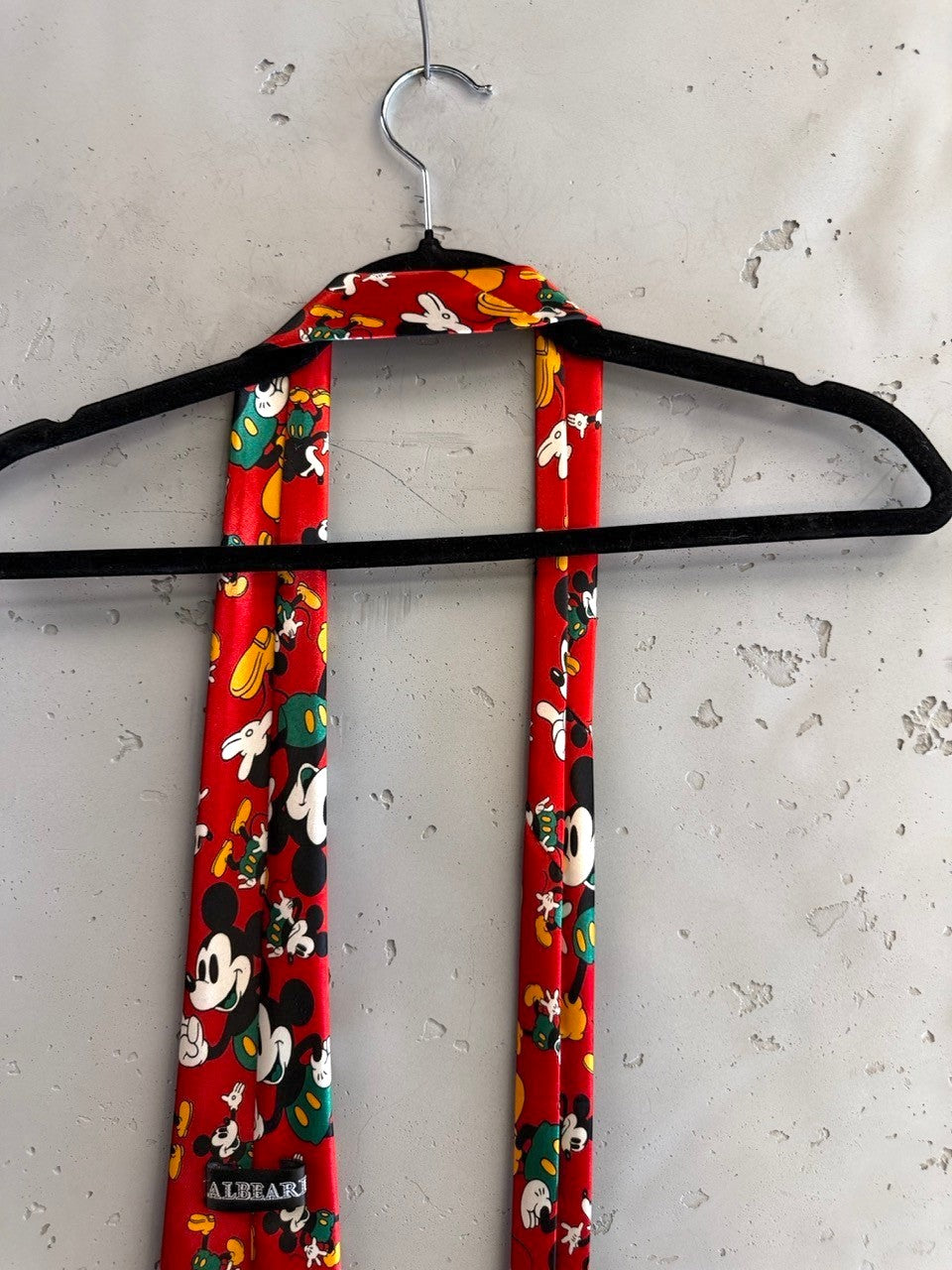 BERLIN VINTAGE CORNER red necktie with all-over Mickey Mouse print in yellow and green.