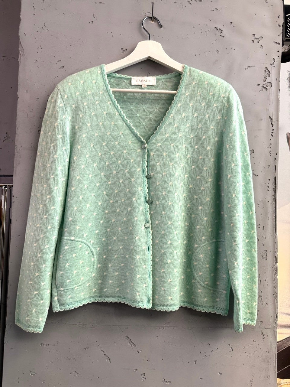 BERLIN VINTAGE CORNER mint green knit cardigan with white polka dots, scalloped trim, and two front pockets.