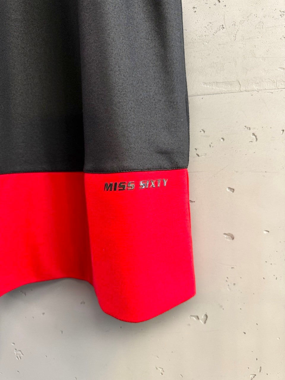 BERLIN VINTAGE CORNER Miss Sixty black mini dress with red hem and embossed logo. Sleeveless A-line.