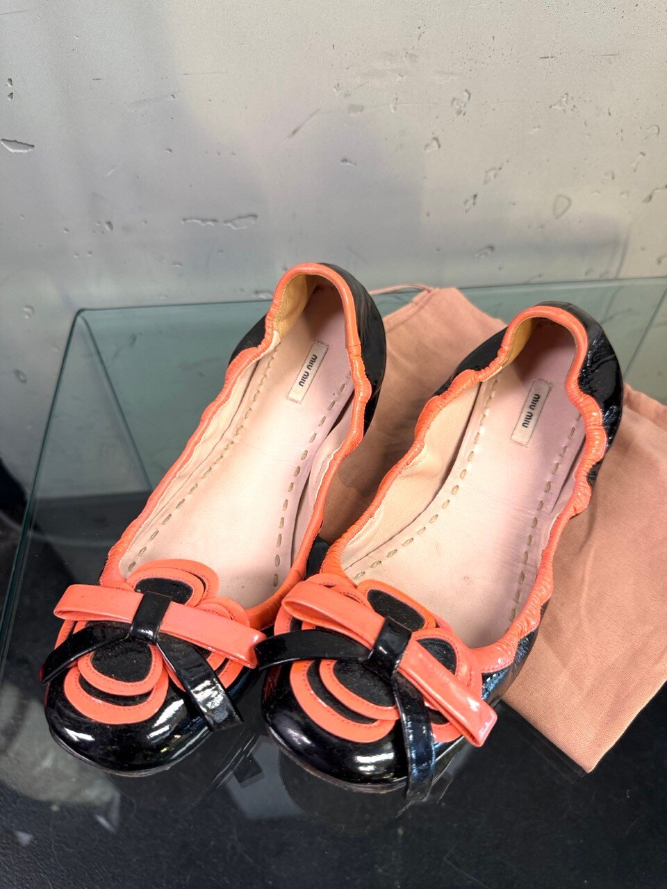 Miu Miu flats, coral buckle ornament in close up