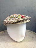 BERLIN VINTAGE CORNER beige monogram flat cap with vibrant floral embroidery on a white mannequin head