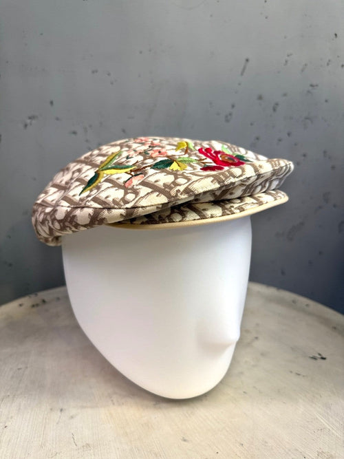 BERLIN VINTAGE CORNER beige monogram flat cap with vibrant floral embroidery on a white mannequin head