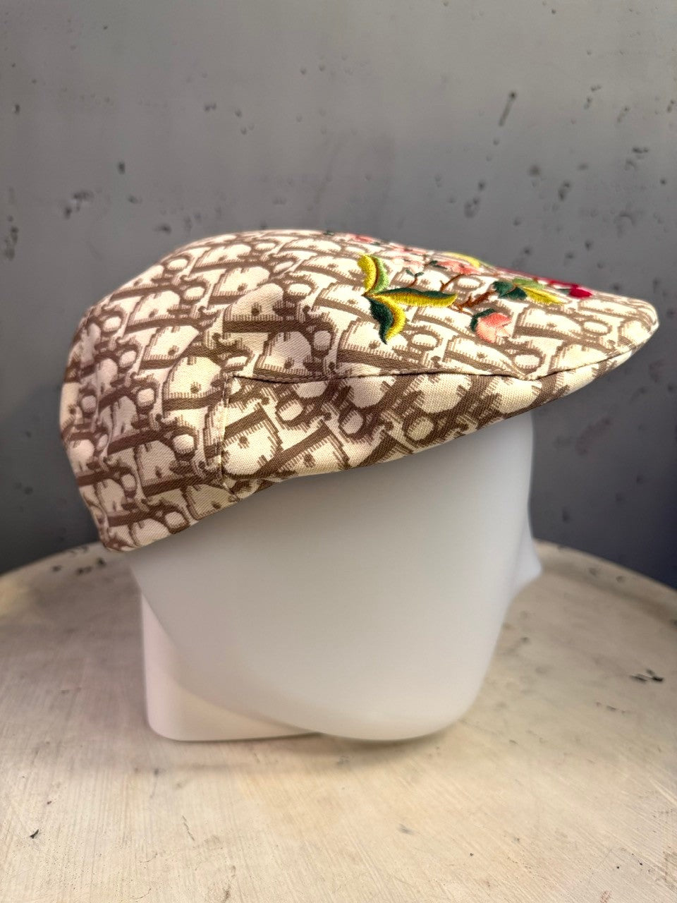 BERLIN VINTAGE CORNER beige and brown monogram canvas flat cap with vibrant floral embroidery on a mannequin head