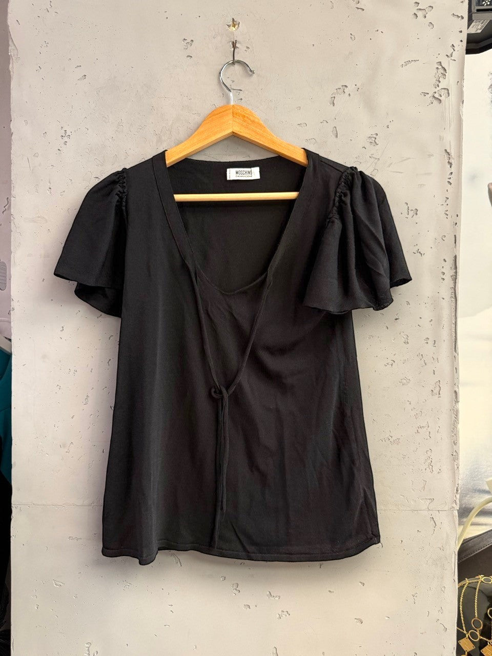 BERLIN VINTAGE CORNER black MOSCHINO CHEAPANDCHIC knit top with V-neck, tie-front detail, and flutter sleeves.