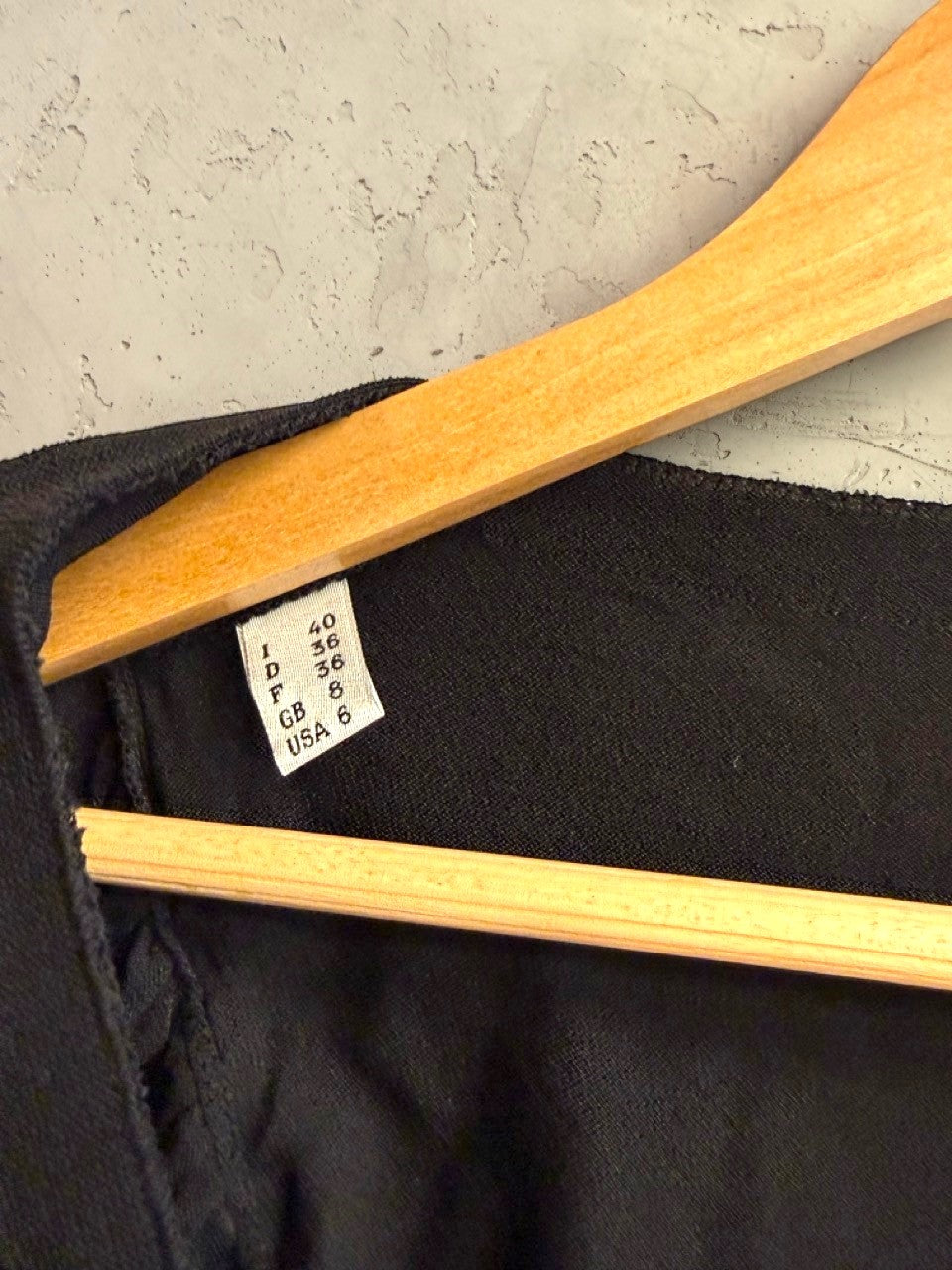 BERLIN VINTAGE CORNER Moschino Cheap and Chic black knit top size label detail on wooden hanger