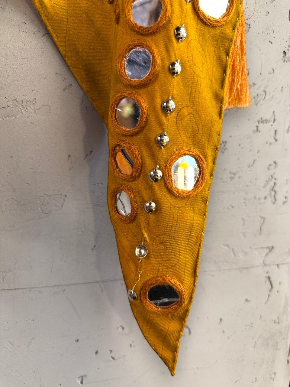BERLIN VINTAGE CORNER mustard Emilio Pucci scarf with circular mirror embellishments, embroidery, and tassel trim.