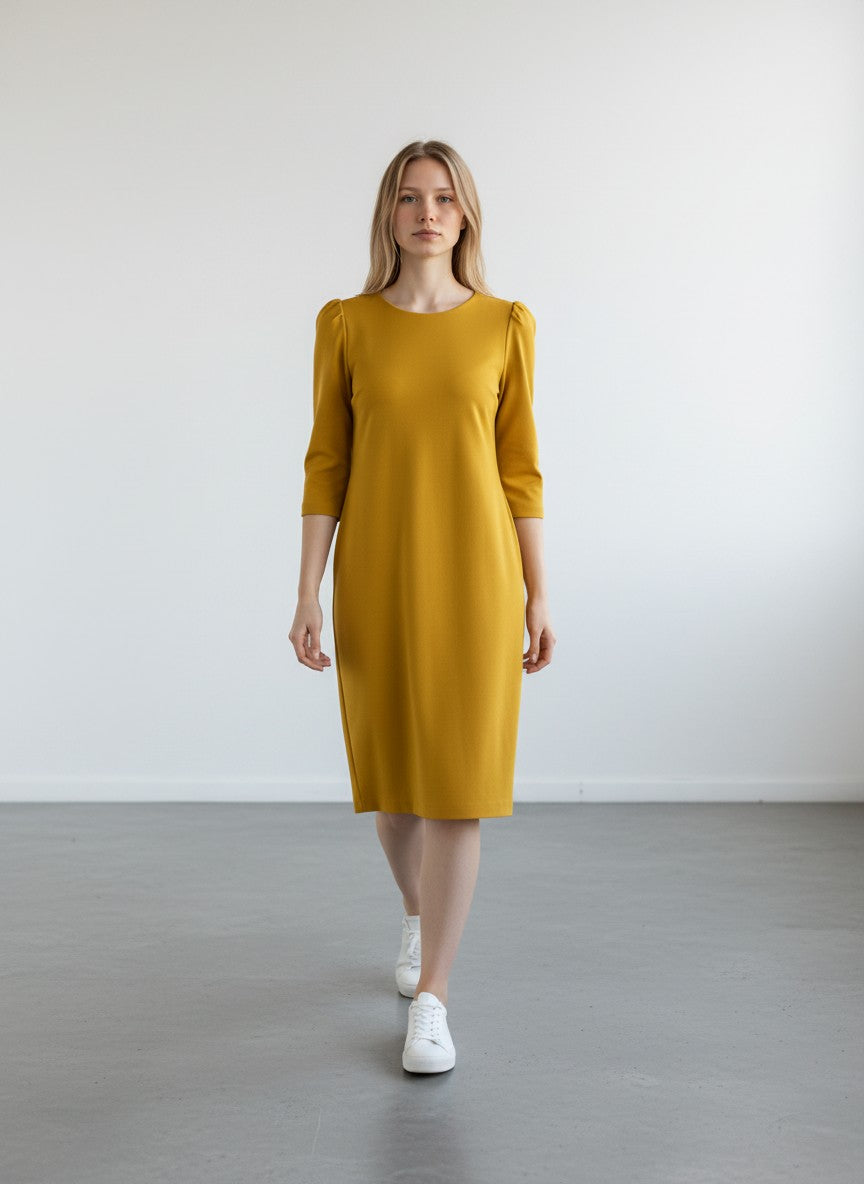 BERLIN VINTAGE CORNER mustard yellow midi sheath dress with elbow-length sleeves and silver zipper detail.