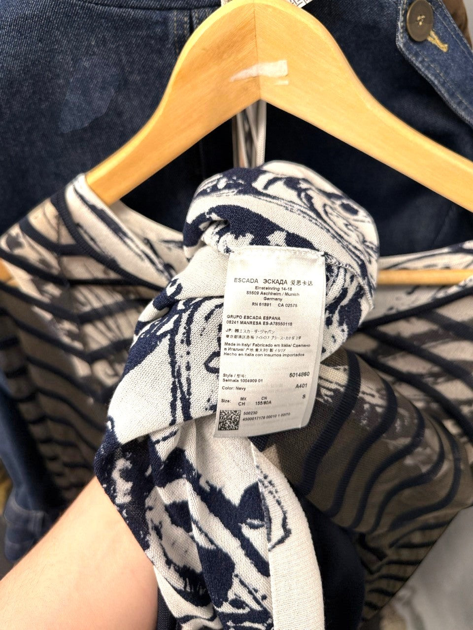 BERLIN VINTAGE CORNER navy and white abstract print sheer V-neck top with black trim detail.