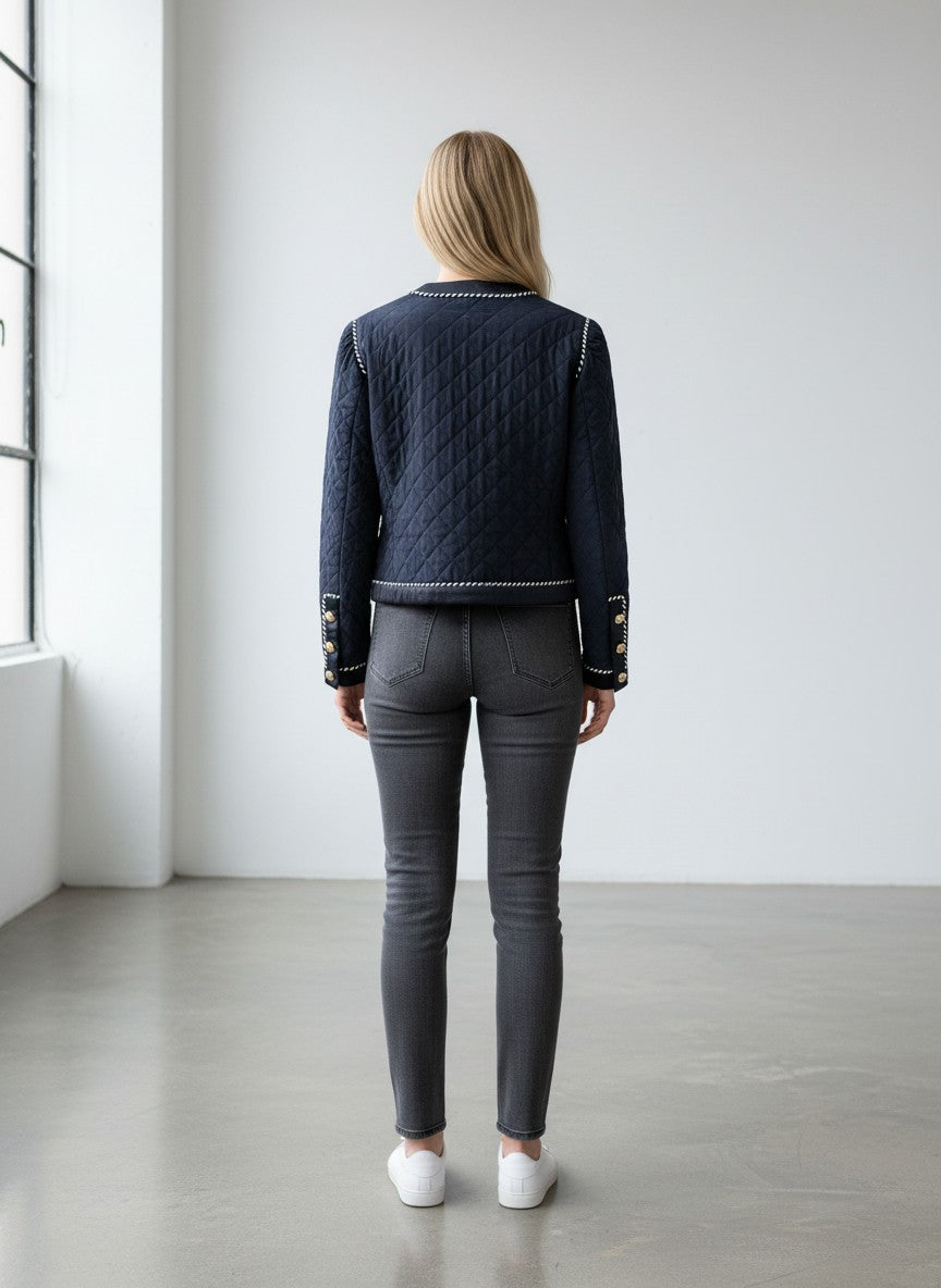 BERLIN VINTAGE CORNER navy quilted jacket with white piping, jeweled buttons, and puffed shoulders.