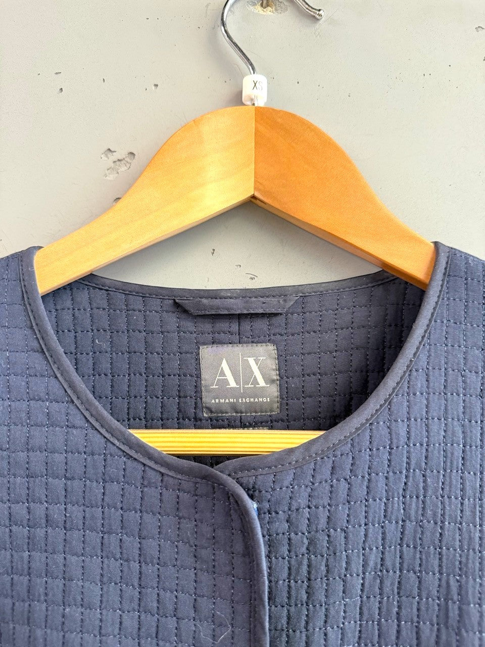 BERLIN VINTAGE CORNER navy quilted jacket with round neckline and button front closure. Features AX Armani Exchange logo.